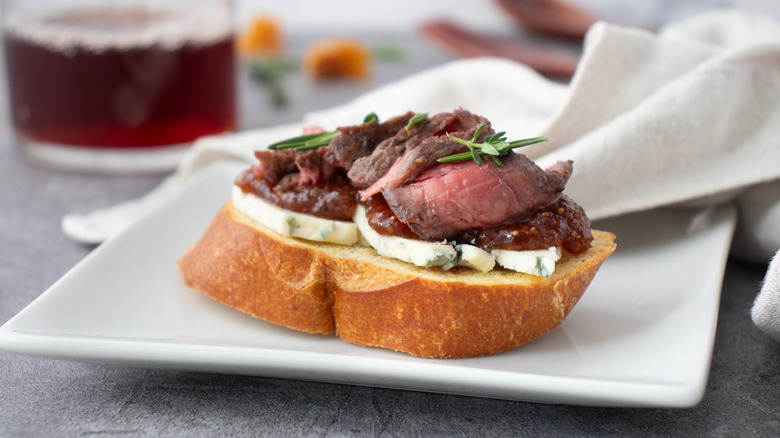 steak blue cheese crostini on white plate