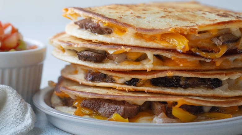 steak fajita quesadillas stacked on plate