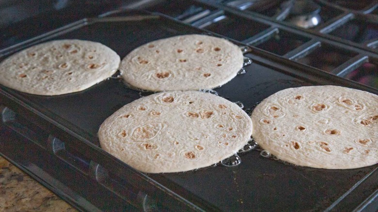 four tortillas on skillet