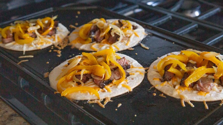 tortillas topped with steak veggies