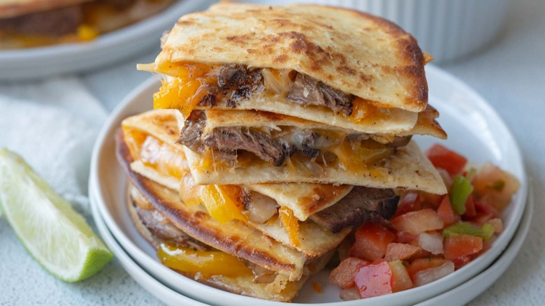 steak quesadillas stacked on plate