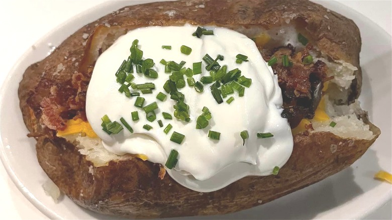 Loaded baked potato on plate