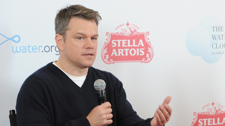 Matt Damon speaking into a microphone 