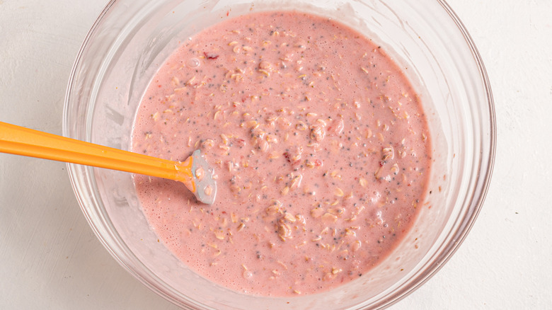 Bowl with strawberry milk, oats, and chia seeds