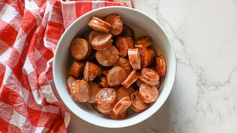 sliced Andouille sausage on a checkered cloth