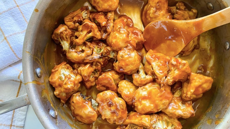 tossing cauliflower in sticky sauce