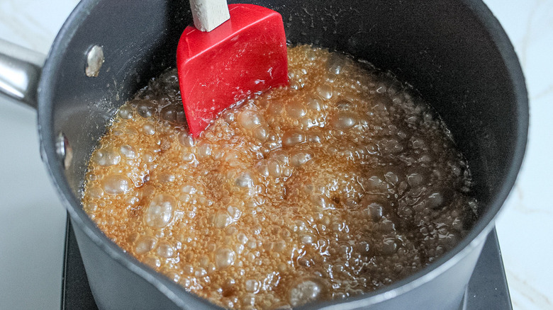 spatula in boiling caramel mixture