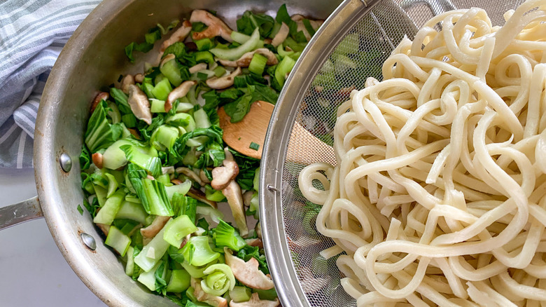 adding noodles to veggies 