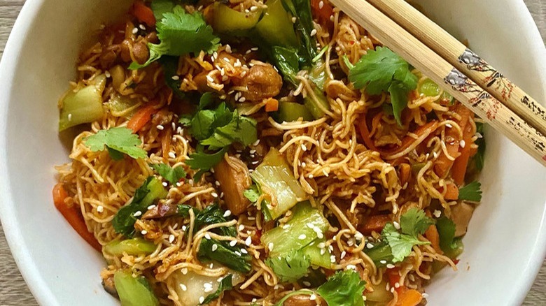 noodles with vegetables and chopsticks