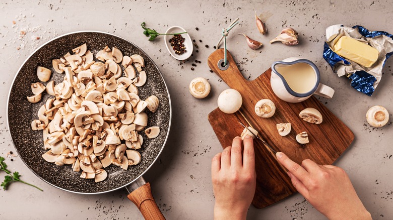 person cutting mushrooms