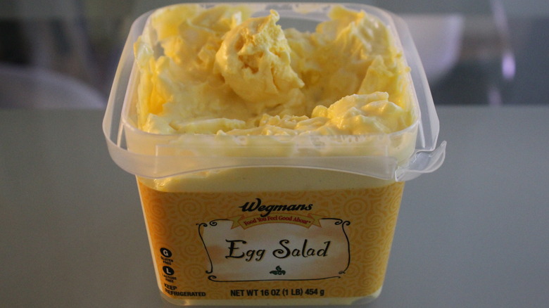 Tub of Wegmas egg salad with large yolk in center