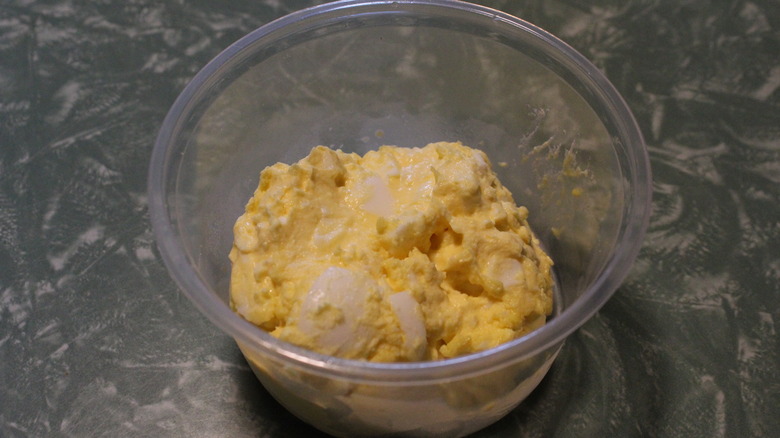 Clear plastic container of egg salad