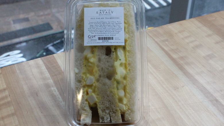 Pre-packaged egg salad sandwich in front of window at Eataly