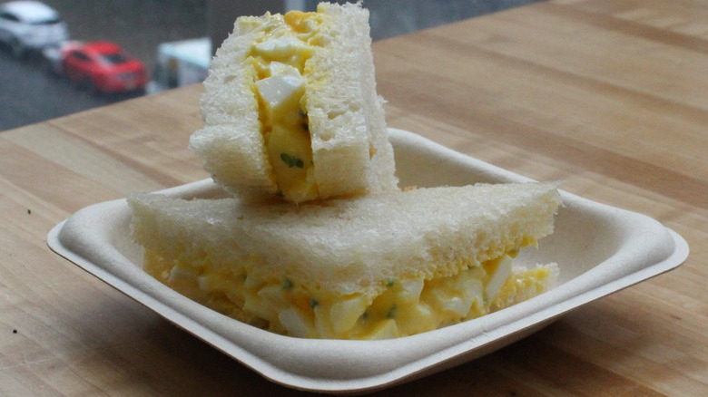 Closeup of egg salad sandwich on crustless white bread