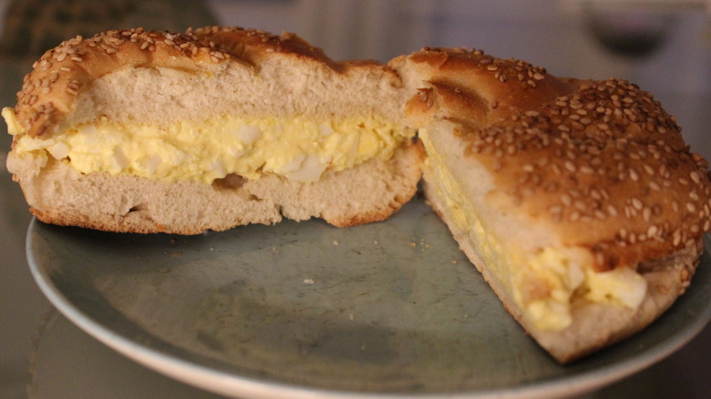 Egg salad sandwich on a sesame seed roll