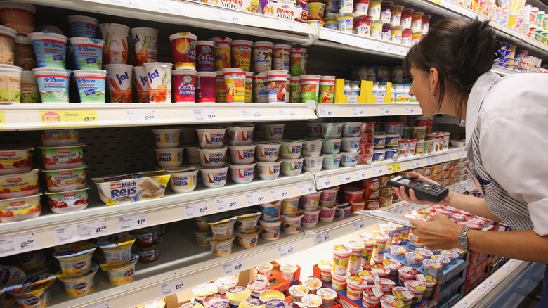 woman looking at yogurt selection