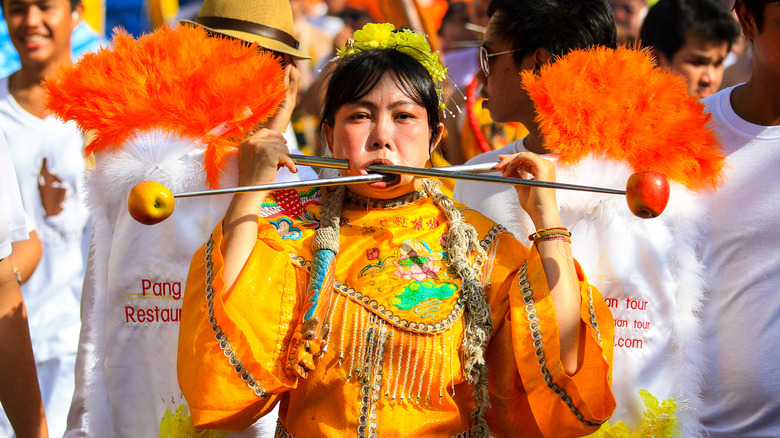 Phuket Vegetarian Festival swords through cheeks