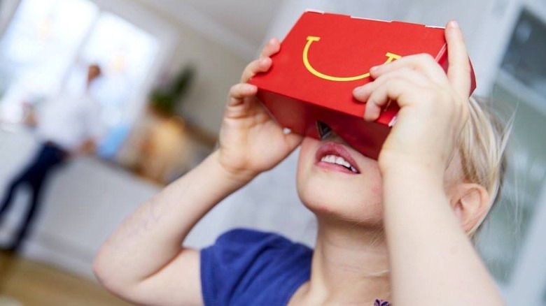 child looking through VR goggles