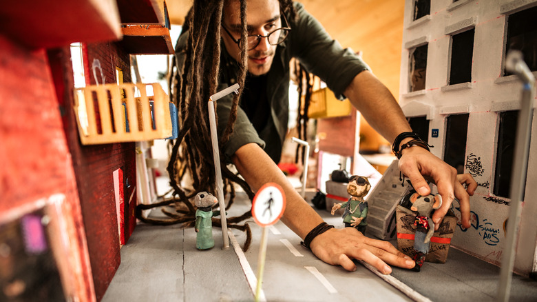 Man working with stop-motion puppets