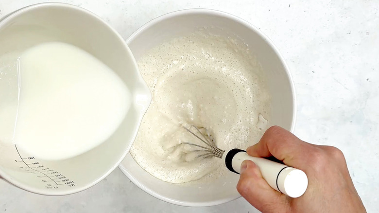 mixing milk in flour