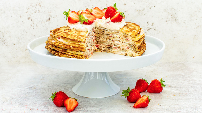 sliced strawberries and cream crepe cake