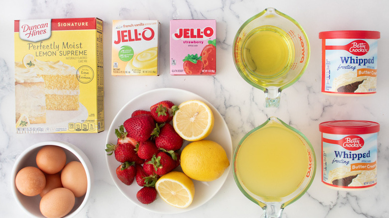 strawberry poke cake ingredients on marble counter