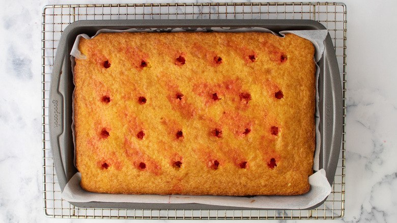 Jell-O poke cake on rack