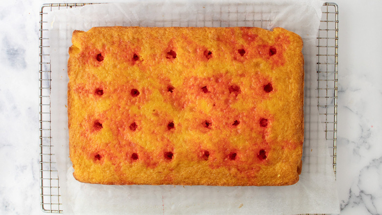 Jell-O poke cake on rack