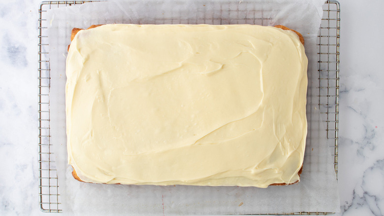 frosted cake on rack