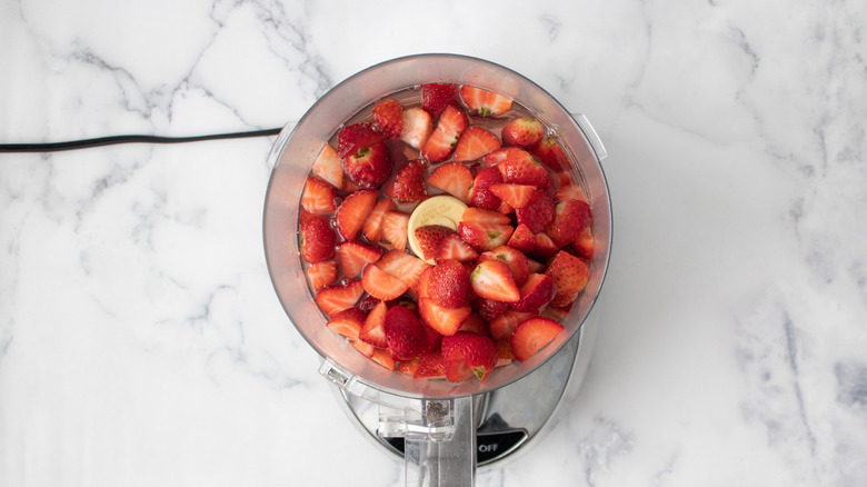 strawberries and syrup in blender