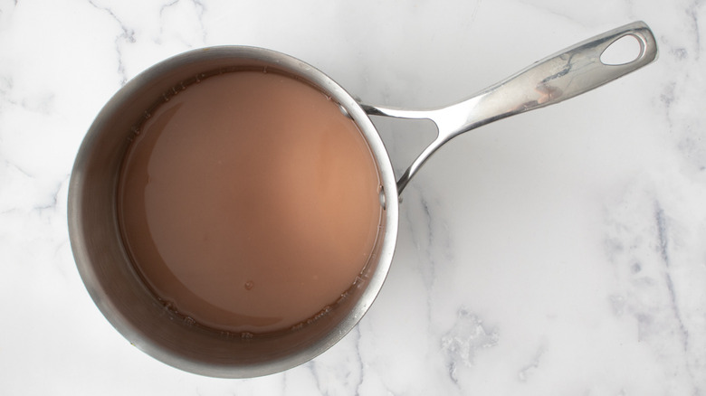 rosé sugar syrup in saucepan