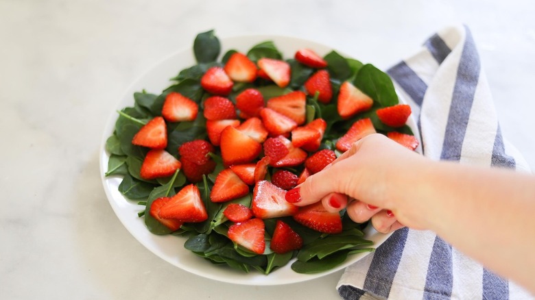 plate of spinach and strawberries