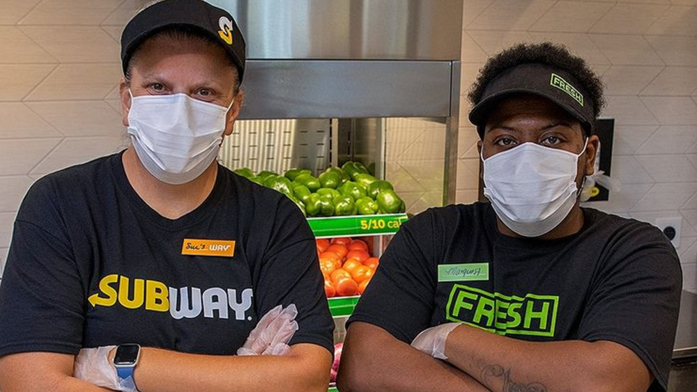 masked and gloved Subway employees