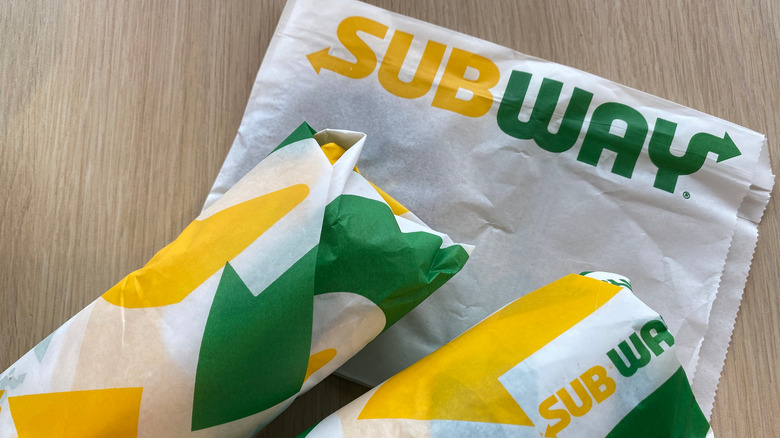 Two wrapped Subway subs