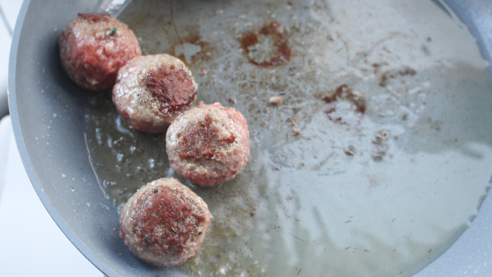 Meatballs cooking in a pan for Subway Meatball Marinara Sub copycat recipe