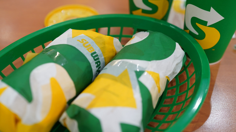 Subway sandwiches in a green basket