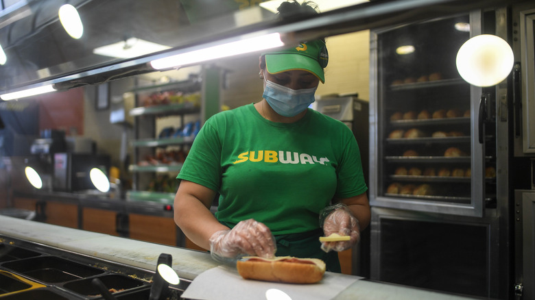 Making Subway sandwich at counter