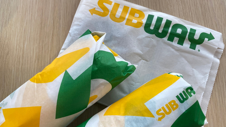 two wrapped subway sandwiches