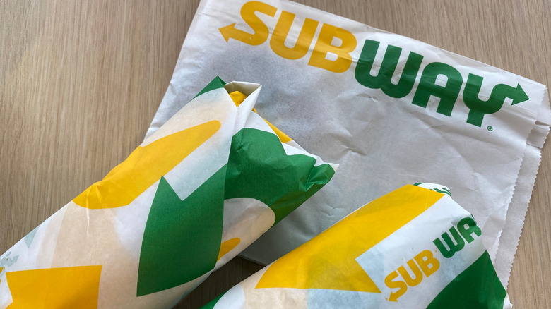 two wrapped-up subway sandwiches