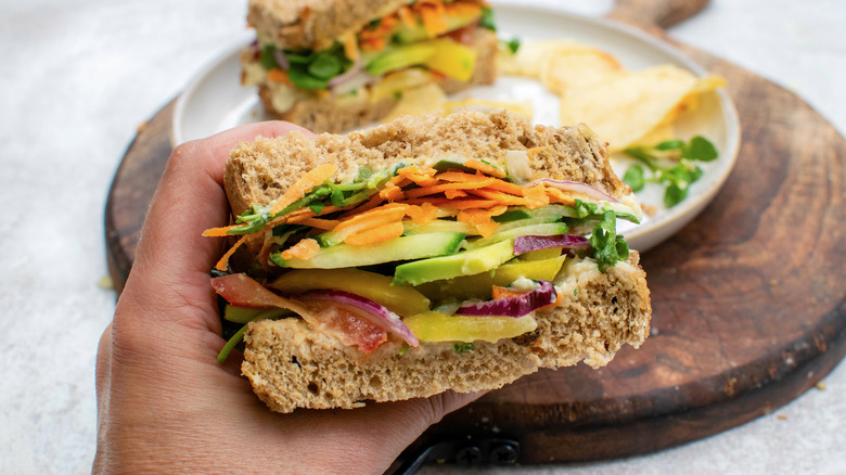 hand holding vegetable sandwich