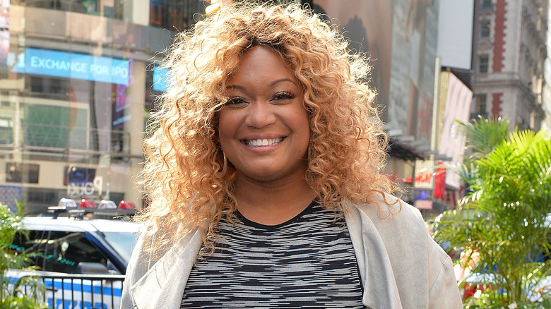 Sunny Anderson smiles in city