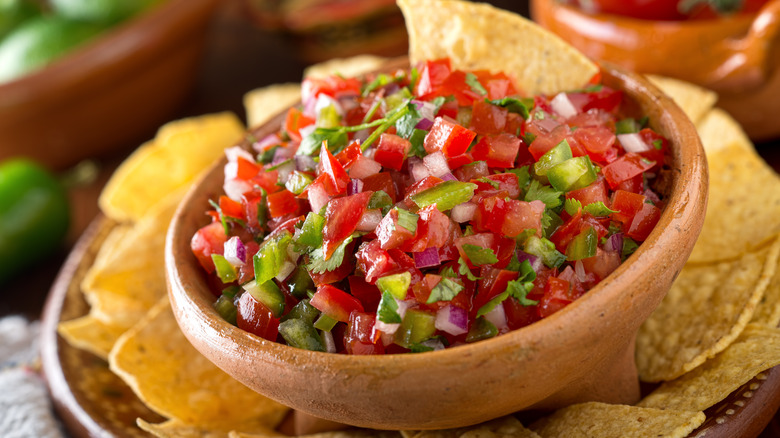 pico de gallo in a wood bowl with tortilla chips