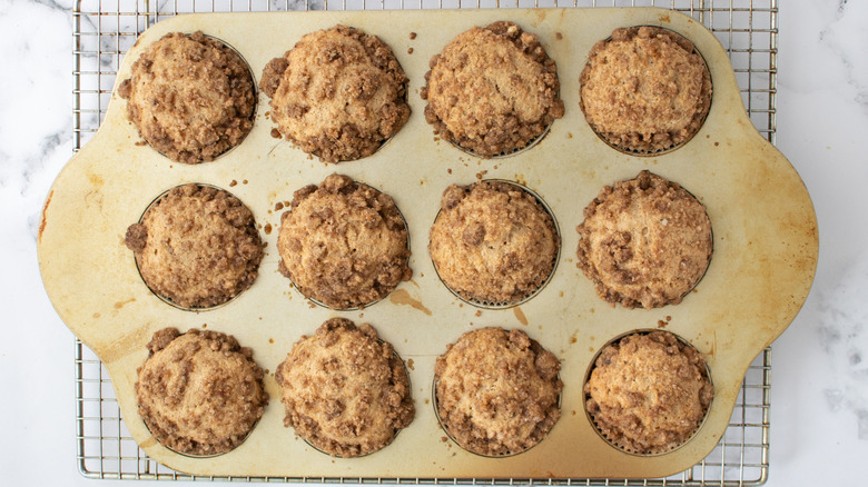 baked snickerdoodle muffins with crumble on wire rack