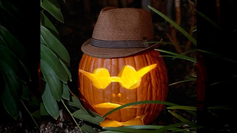 A pumpkin carved to look like its wearing glasses and a bowtie