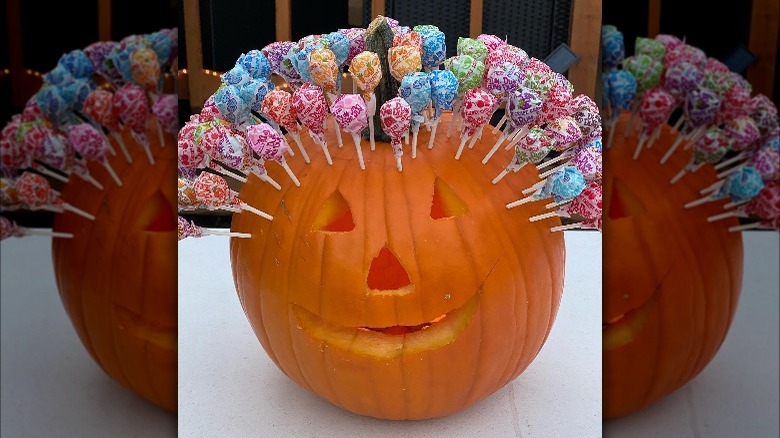 A jack-o-lantern with suckers stuck in it