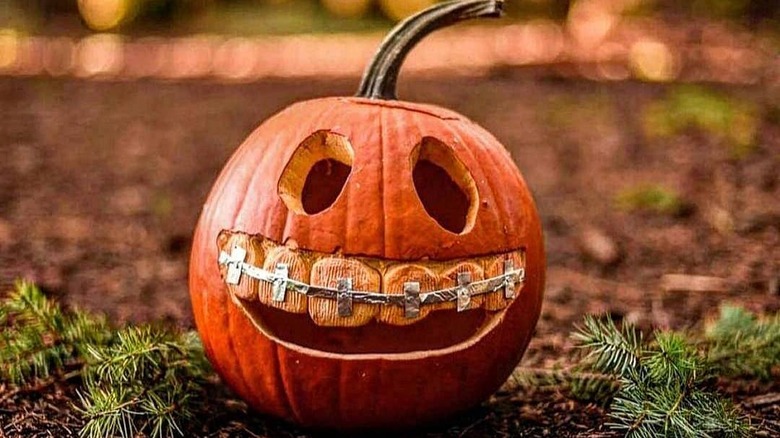 A carved jack-o-lantern with braces