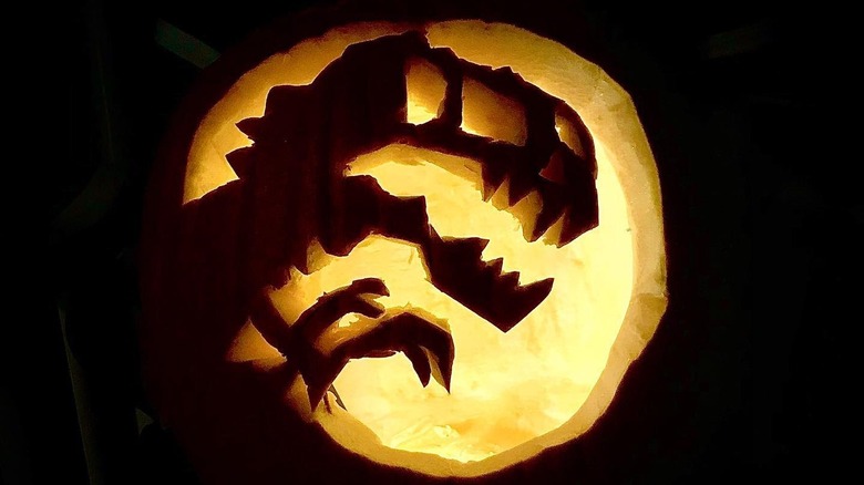 A pumpkin with a dinosaur carving