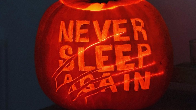 A pumpkin carved with the words "Never Sleep Again"