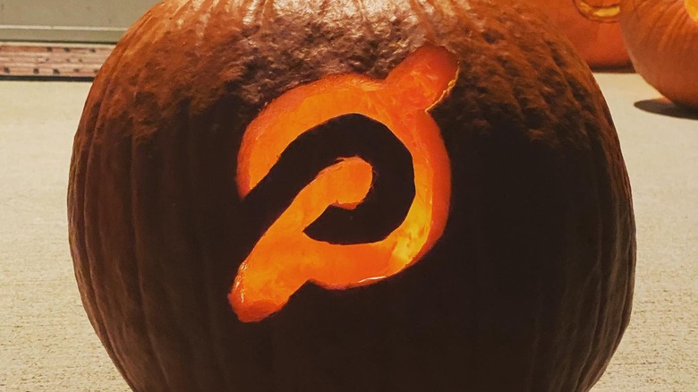 A pumpkin with the Peloton logo carved in the side