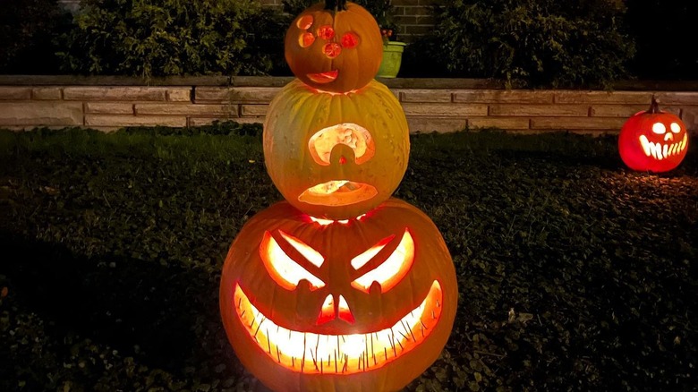 Three stacked and carved pumpkins